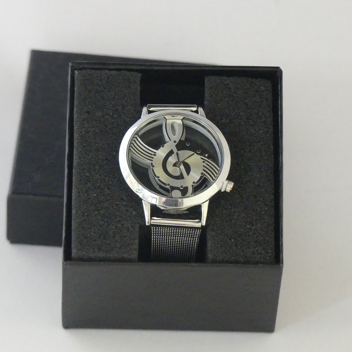 Horloge met transparante kast en ingelegde G-sleutel.